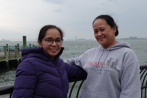 Alyssa Tumulak, Grandison's Professional Development Services Head (R), with Richie Carrido (L) — Grandison's 300th deployed nurse — at the Battery Park, with the Statue of Liberty on the background. The monument has welcomed generations of immigrants to American shores. For Richie, it was a second welcome. For Grandison, it is a reminder of why ethical recruitment exists.